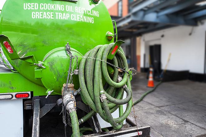 septic tank pump truck in operation in Arlington